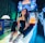 A person sitting on an arcade game machine platform with neon lights in the background. The arcade game is called 'Lane Master' and features a colorful design with bowling-themed imagery.
